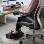 Woman with footrest in home office