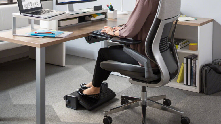 Woman with footrest in home office
